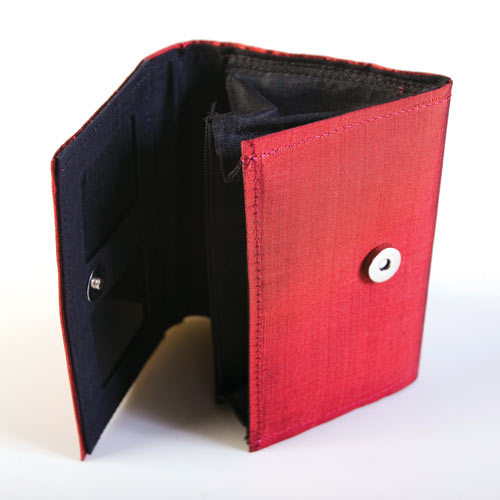 Item 010 : Palin : Coloured/patterned raw silk purse. Internal open and zipped pockets and transparent window pocket for ID, etc. Metal clasp to close.